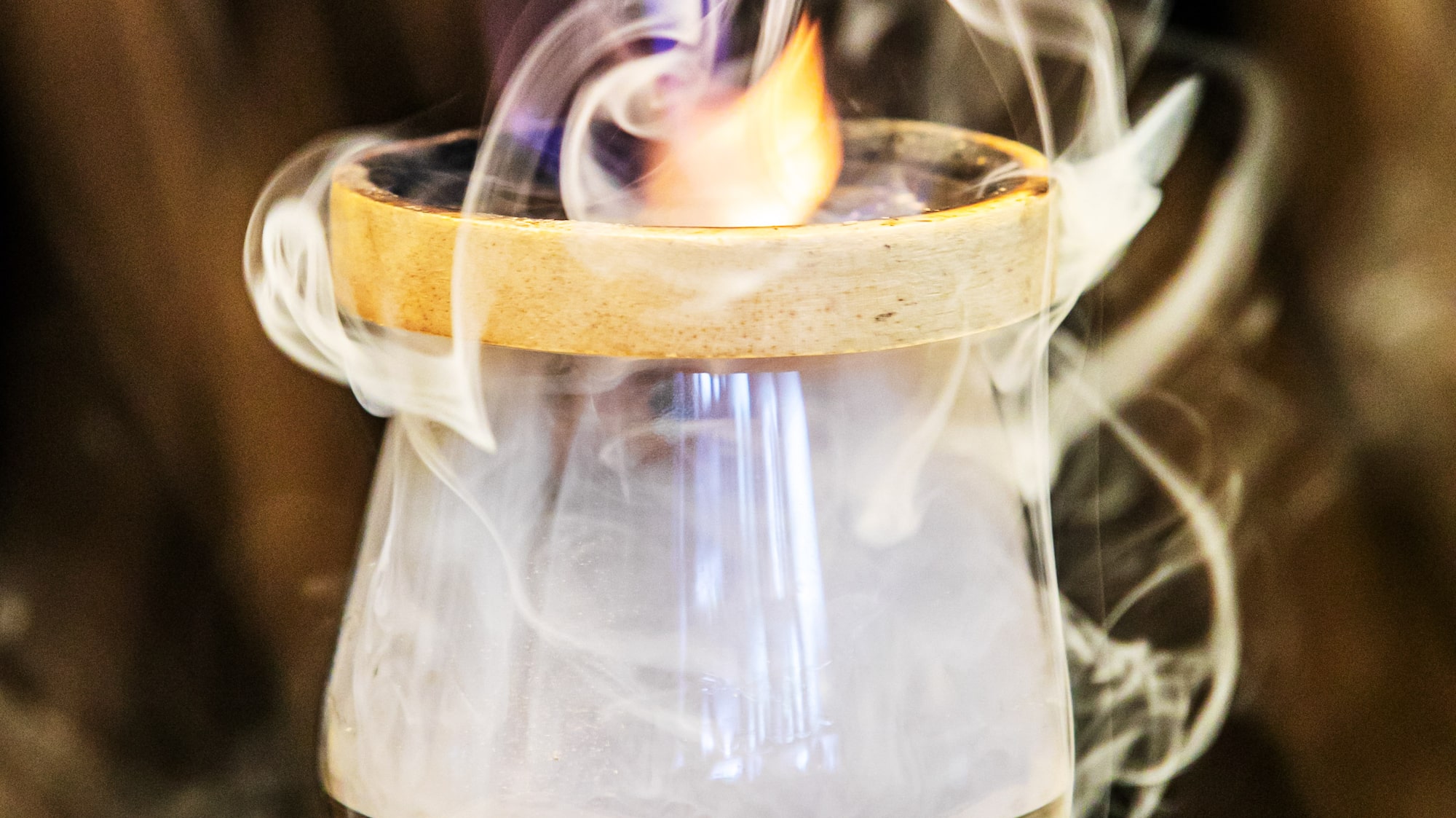 a flame in a glass with smoke