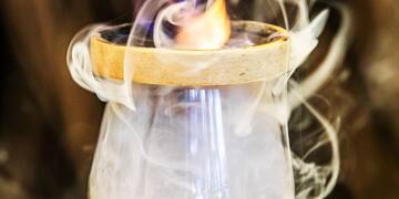 a flame in a glass with smoke