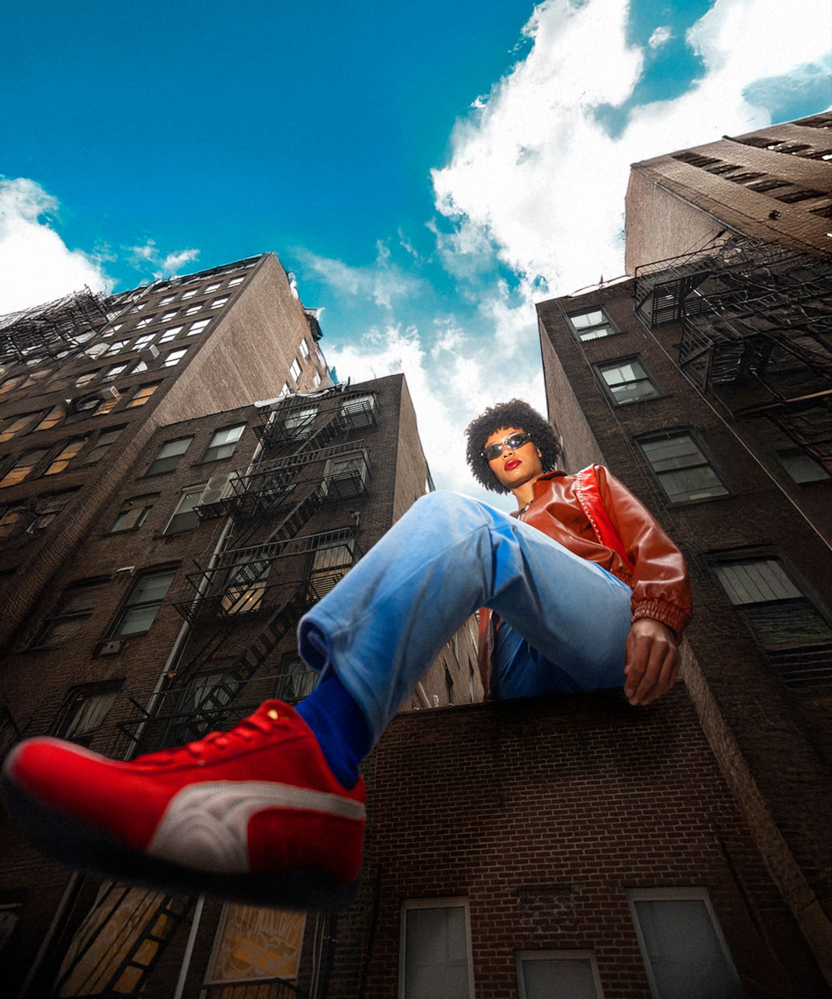 a man sitting on a ledge of a building