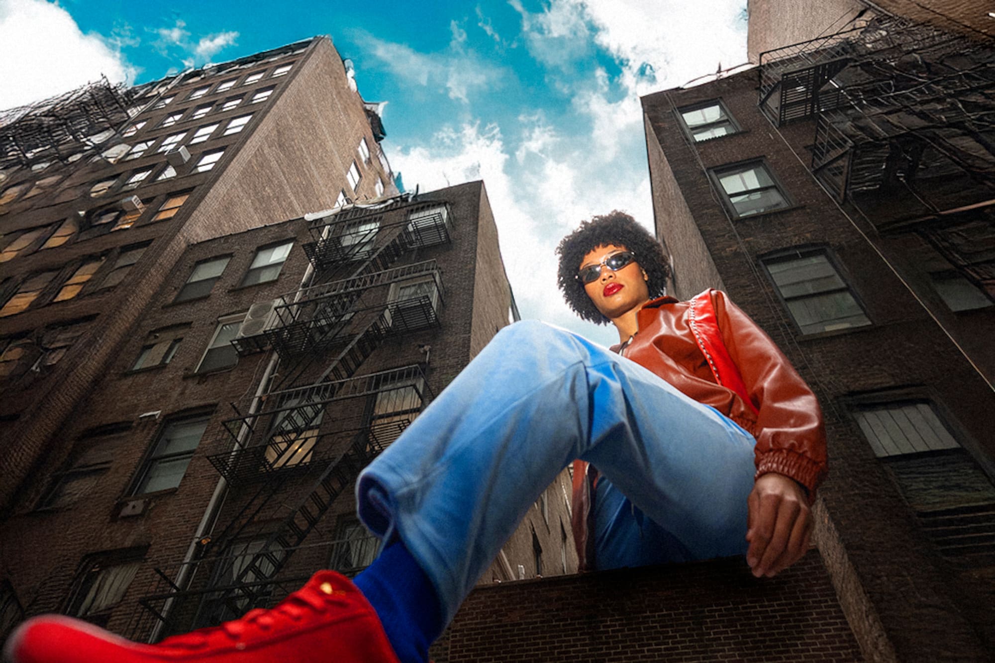 a man sitting on a ledge of a building