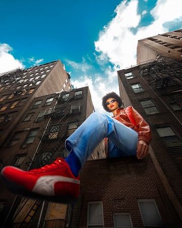 a man sitting on a ledge of a building