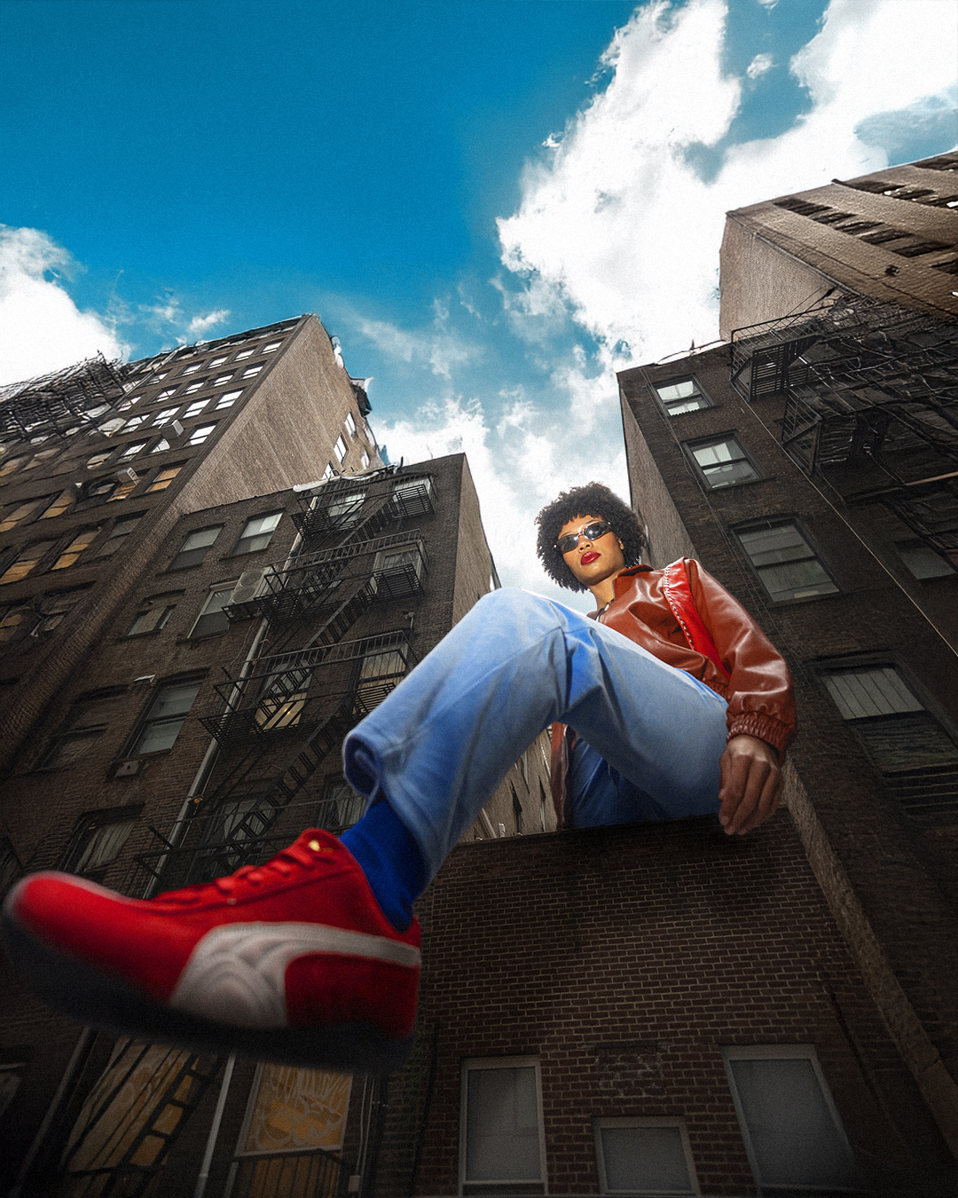 a man sitting on a ledge of a building