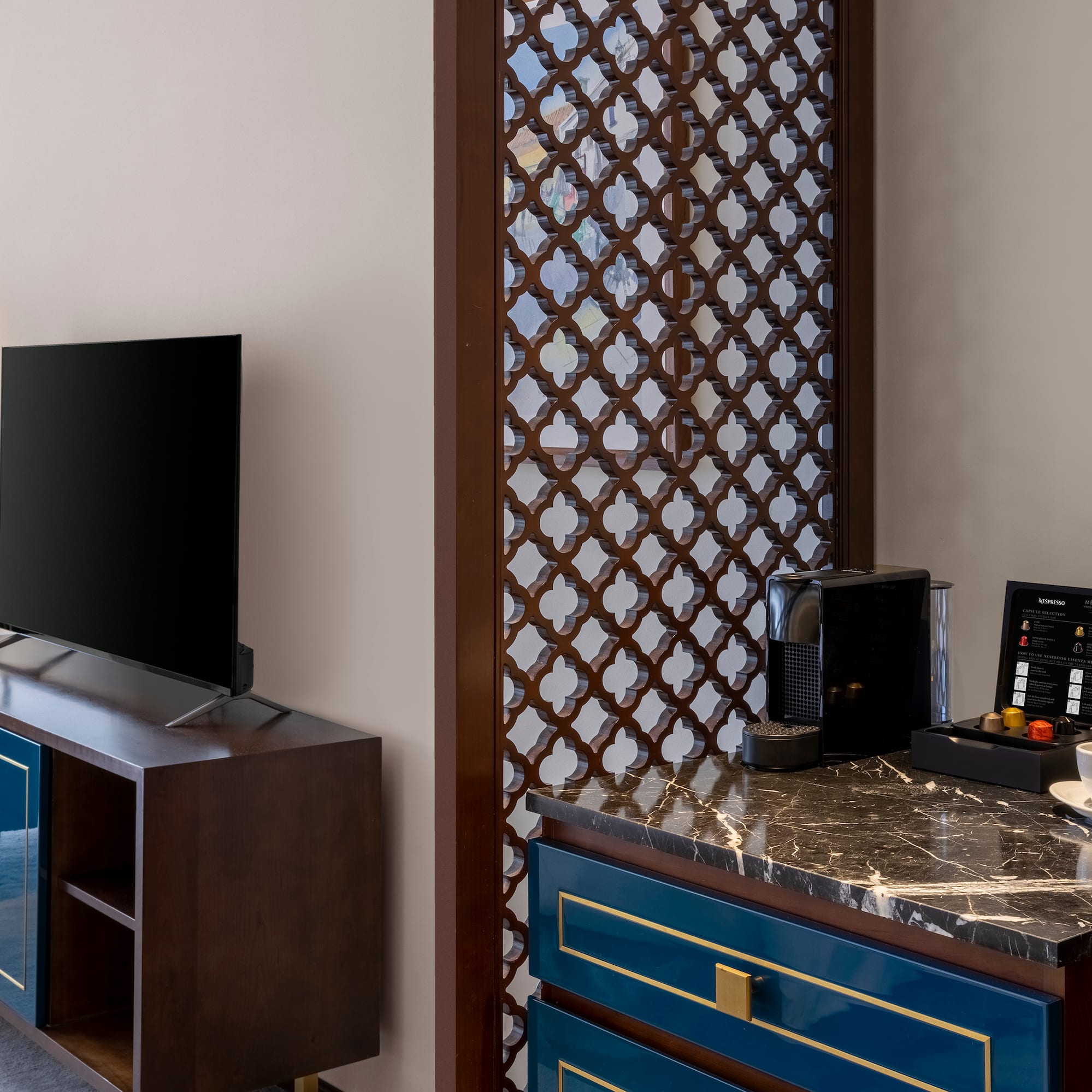 a room with a tv and a blue dresser