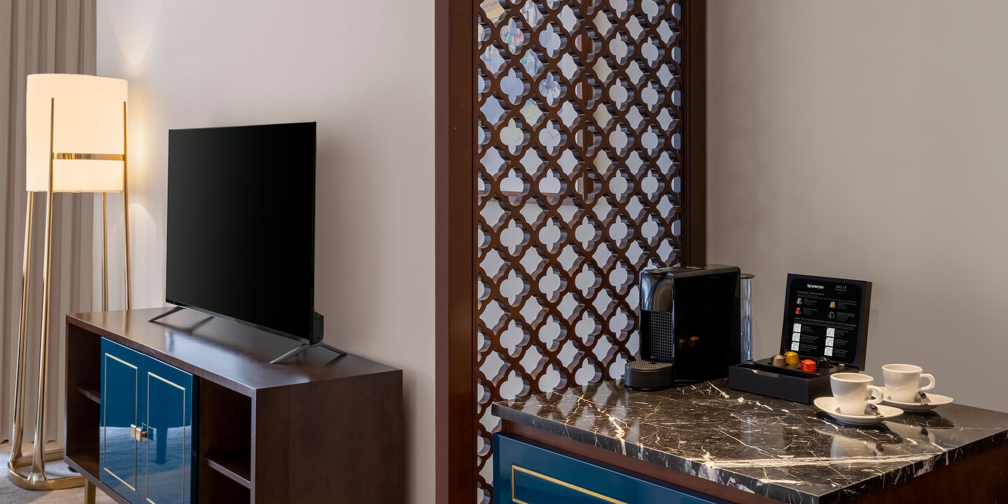 a room with a tv and a blue dresser