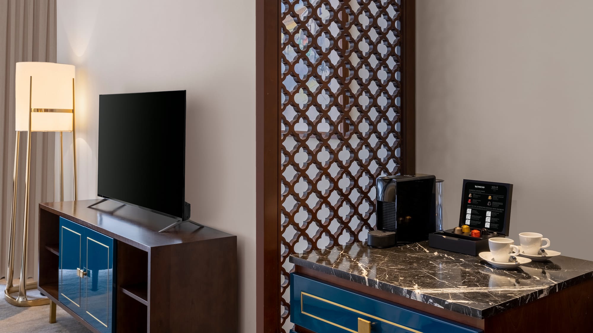 a room with a tv and a blue dresser