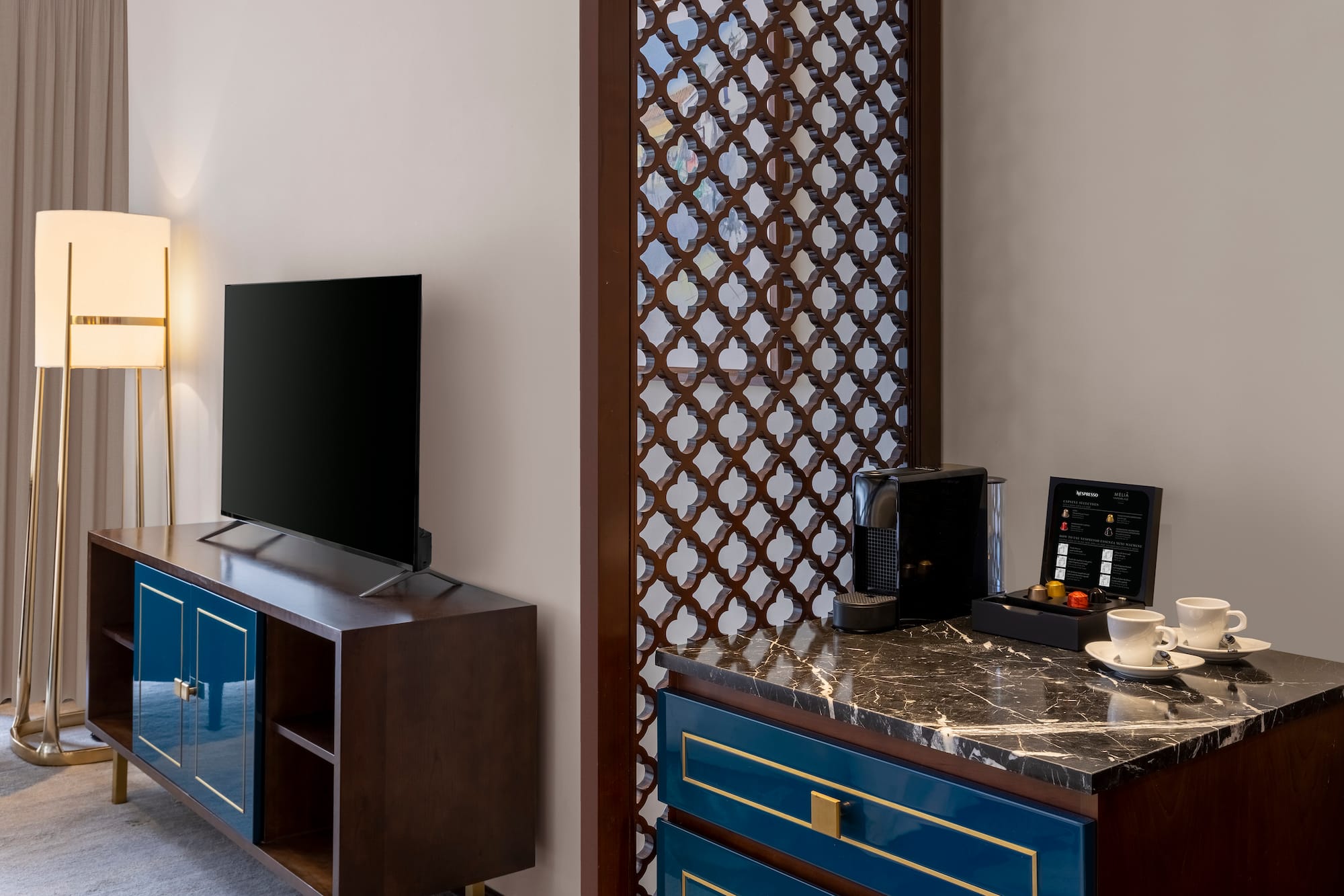a room with a tv and a blue dresser