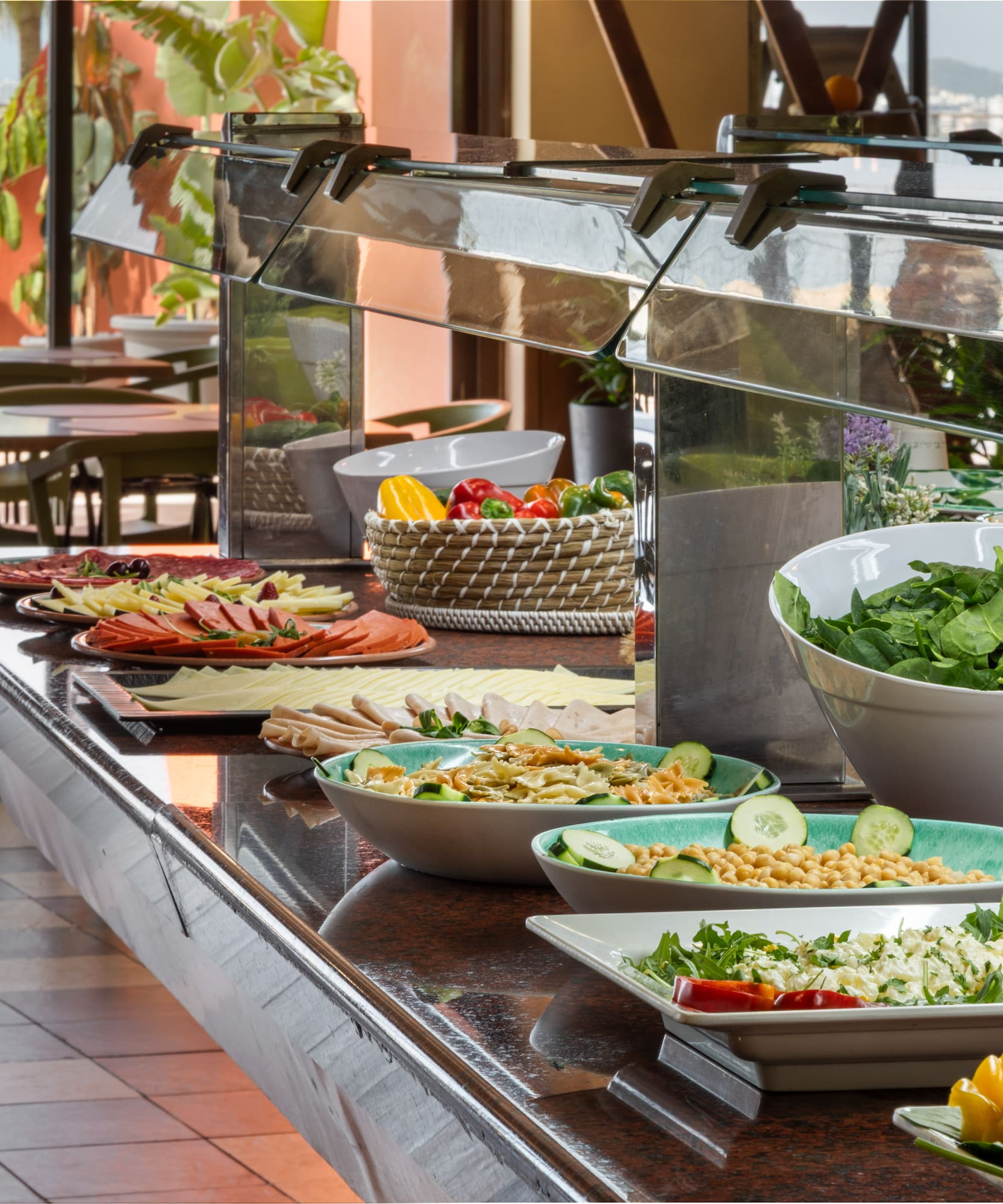 Resort buffet with fresh salads, cold cuts, and ocean view dining.