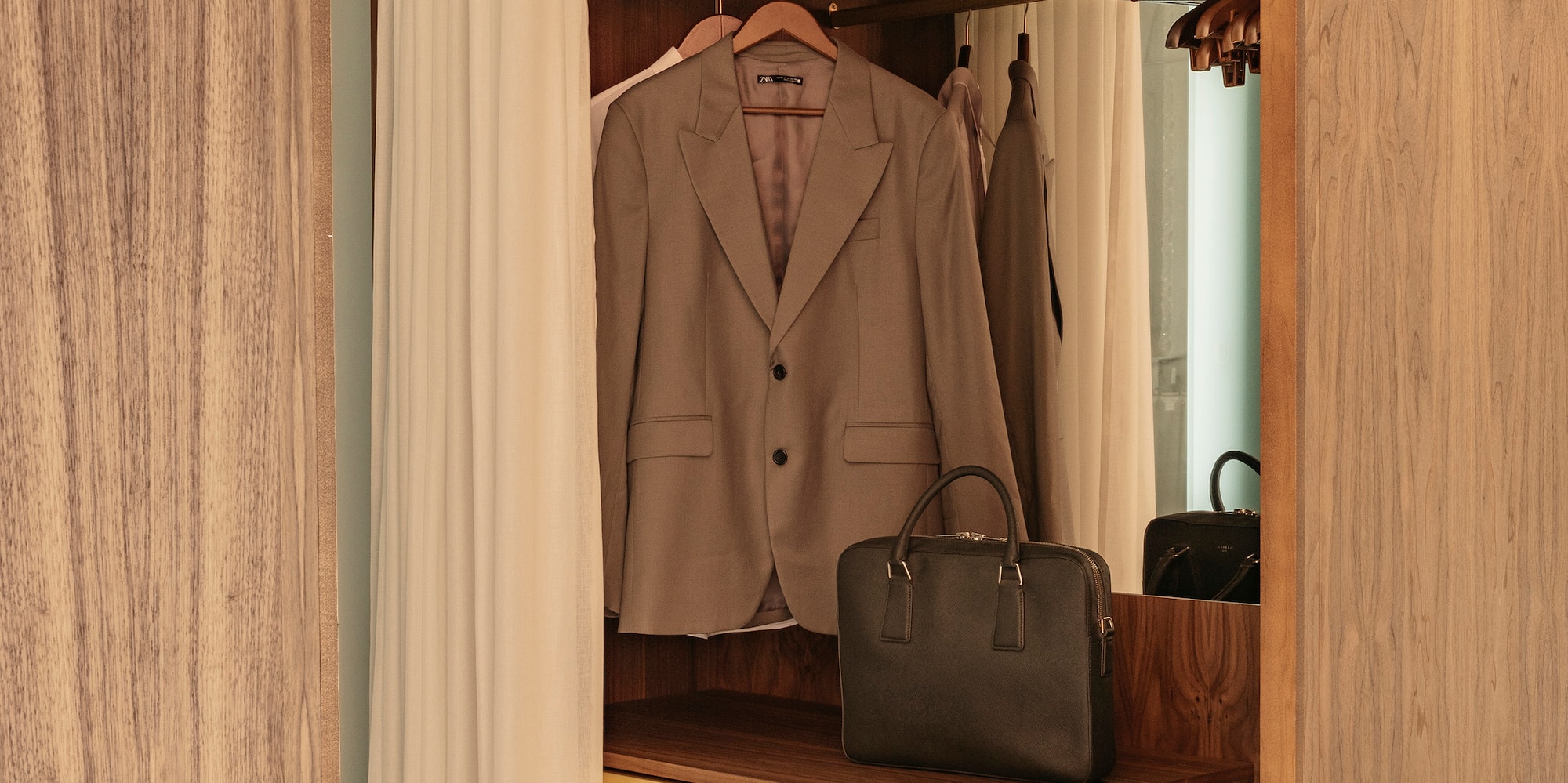 a closet with a jacket and a purse