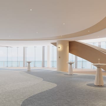 a large room with a staircase and tables