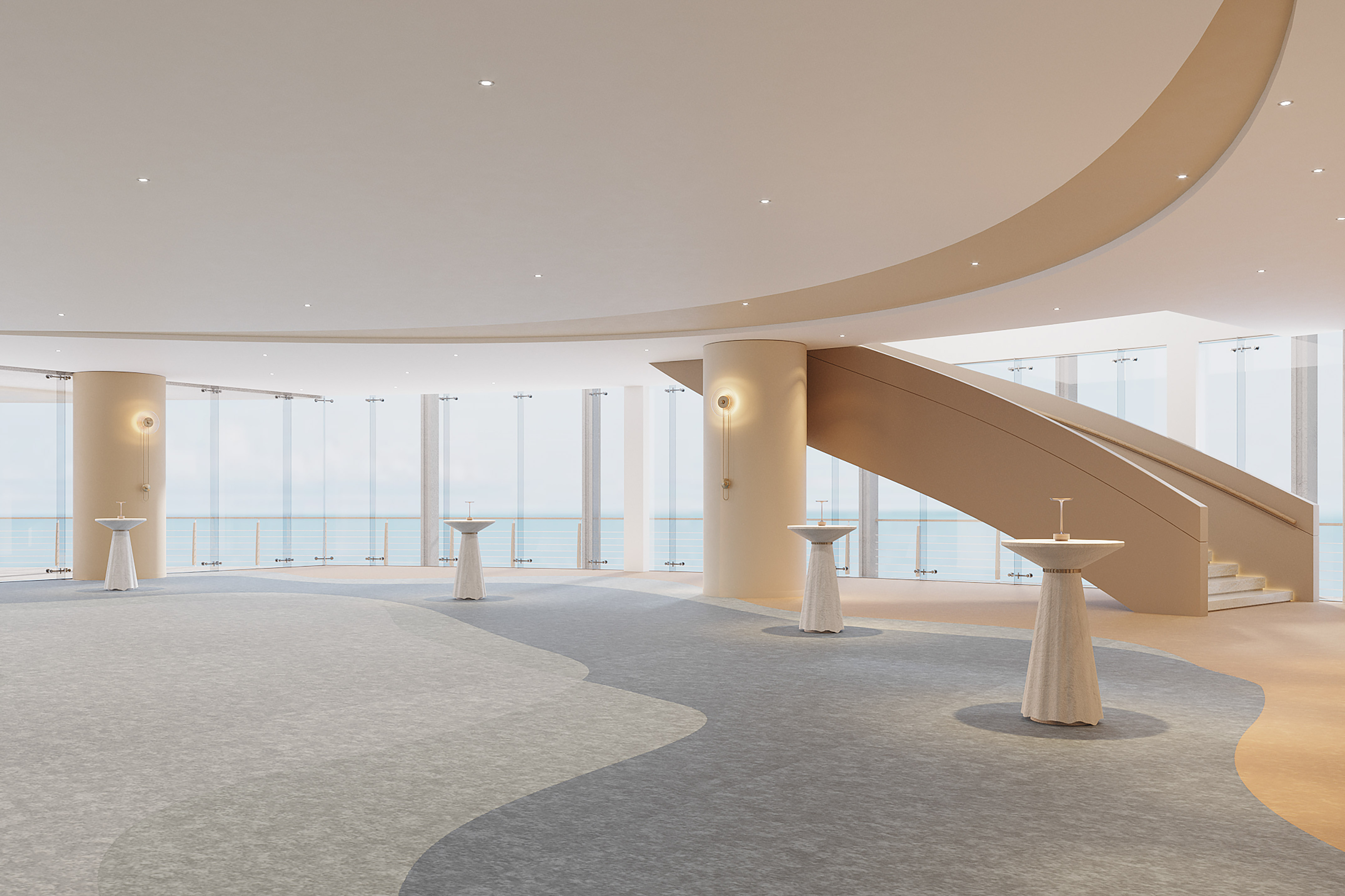 Modern event space with ocean view, curved staircase, and cocktail tables.