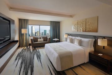 a hotel room with a large bed and a couch