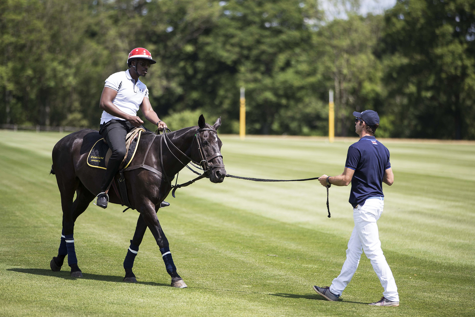 a man on a horse pulling another man on a leash