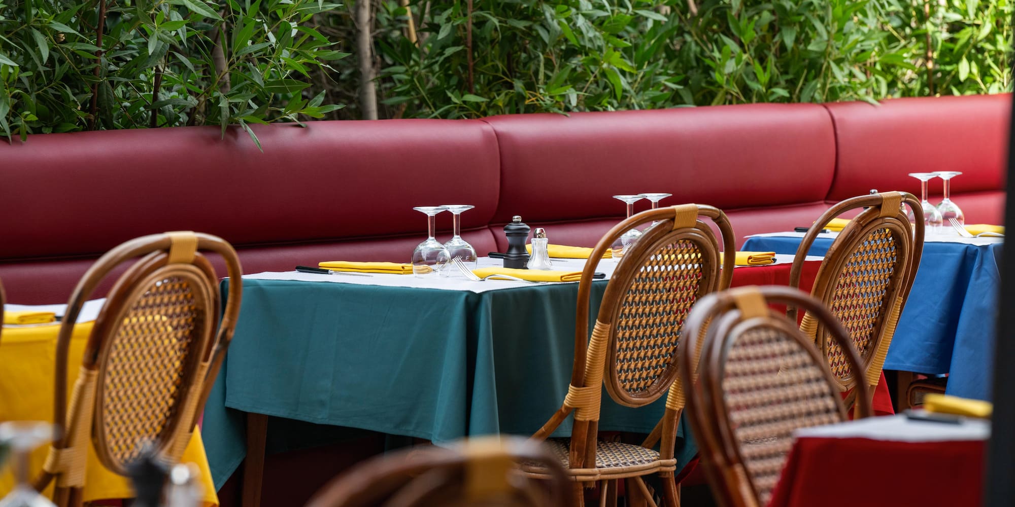 a table with wine glasses and napkins on it