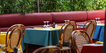 a table with wine glasses and napkins on it