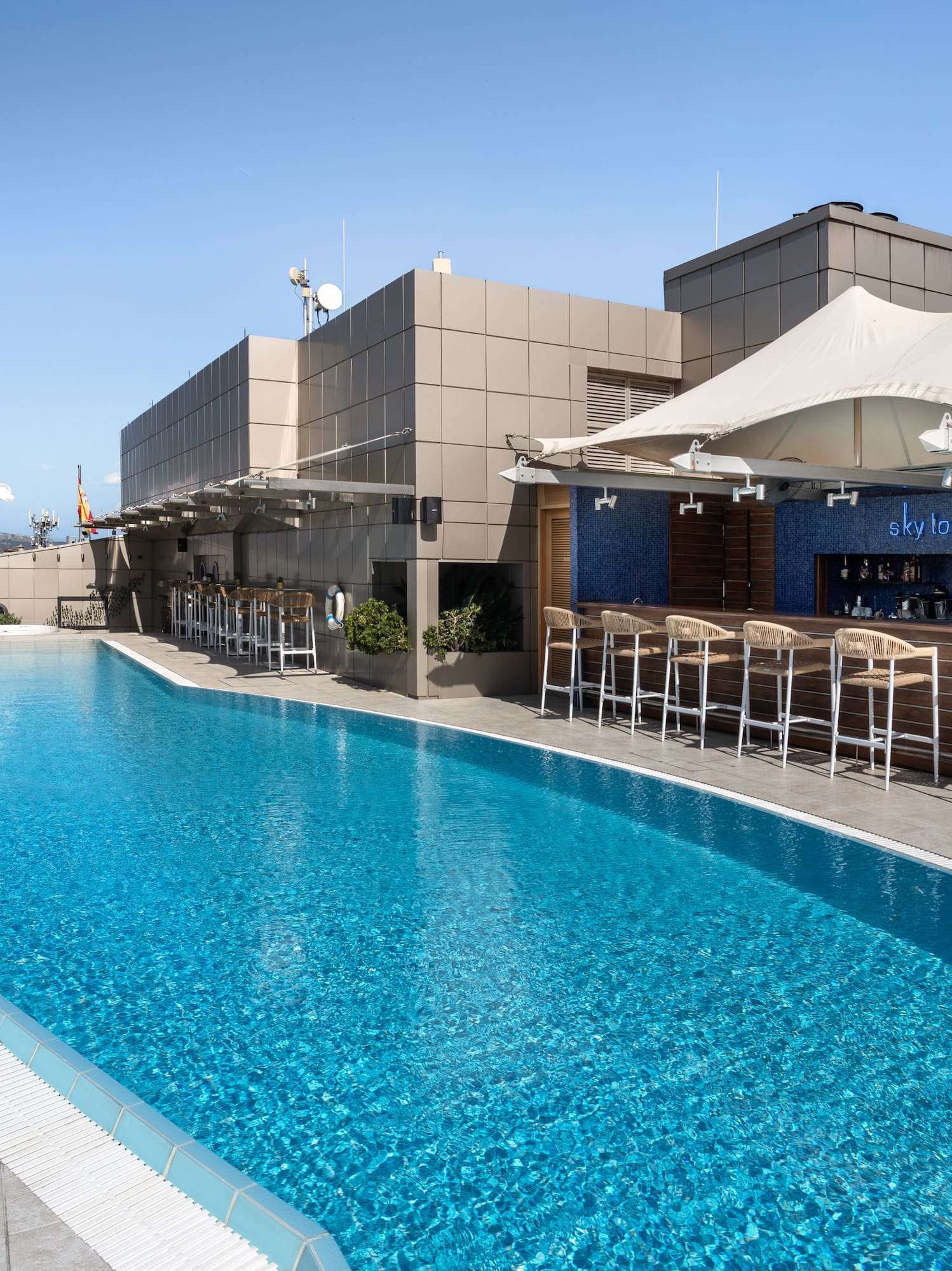 Rooftop swimming pool and Sky Lounge bar with sun loungers and city views.