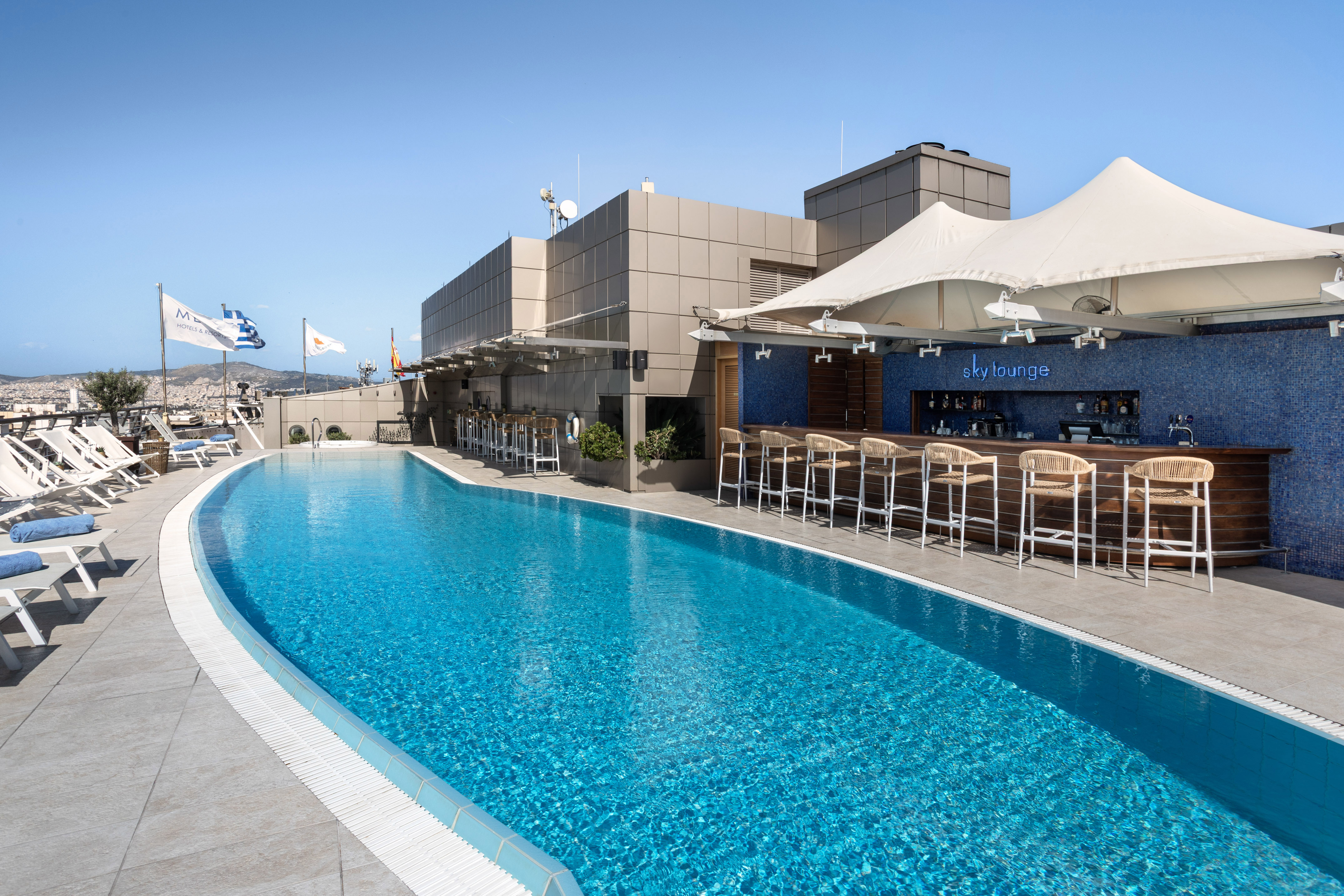 Rooftop swimming pool and Sky Lounge bar with city view.