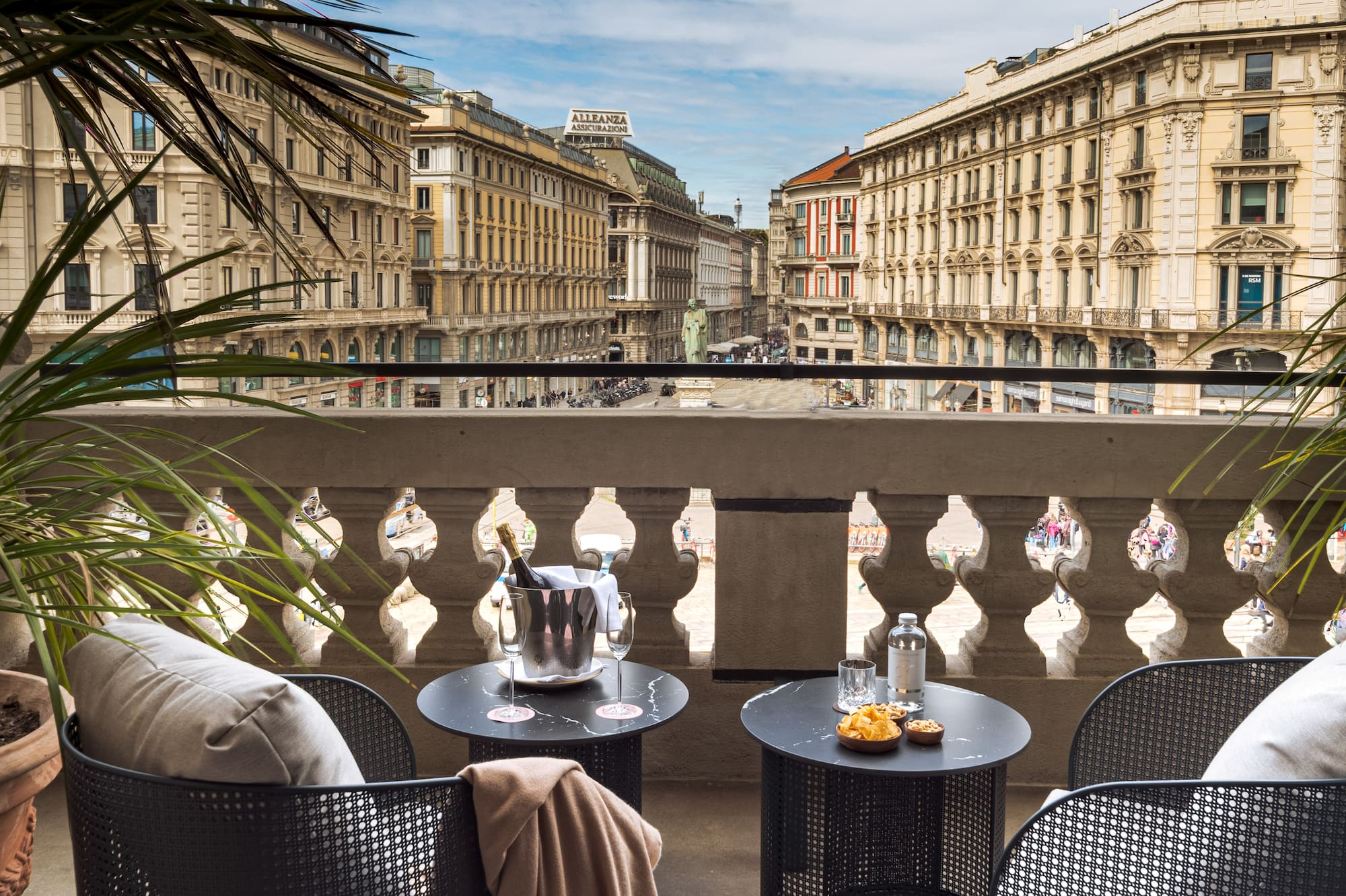 a balcony with chairs and tables