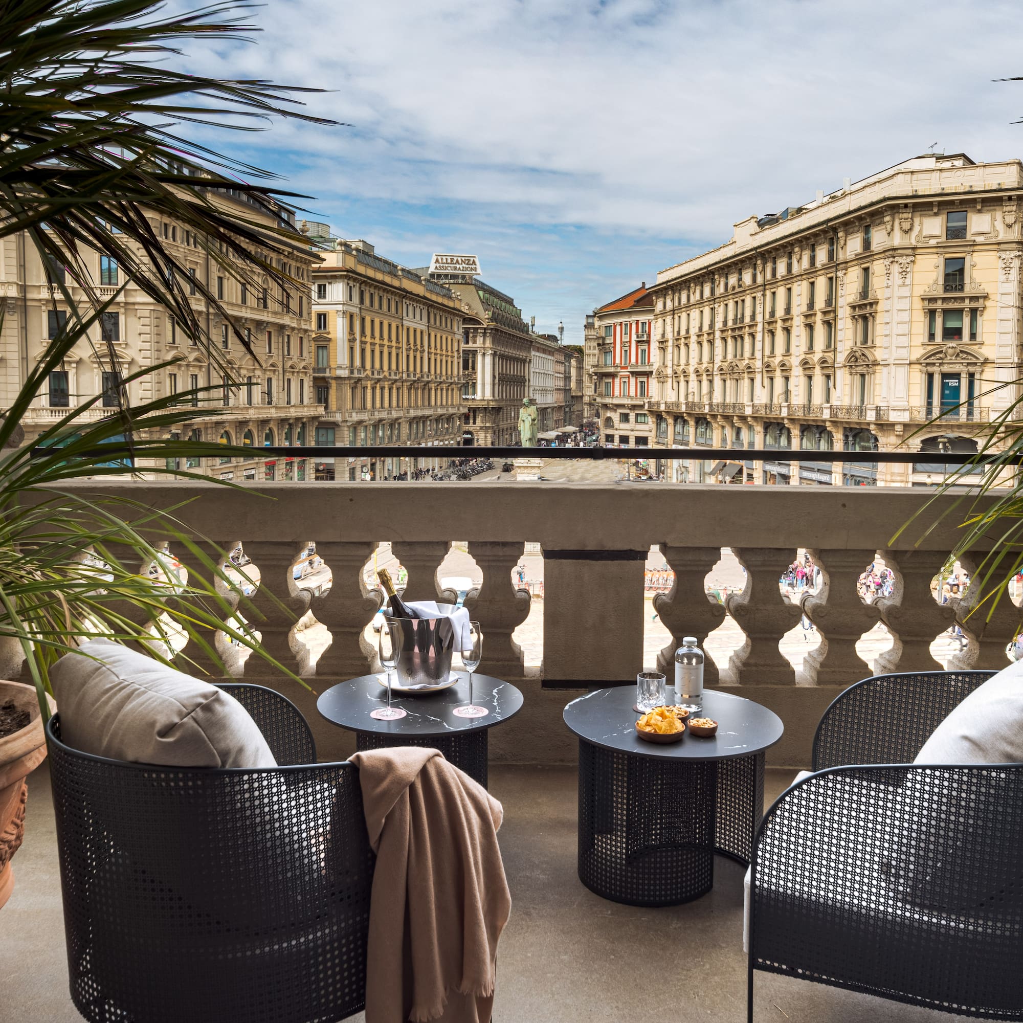 a balcony with chairs and tables