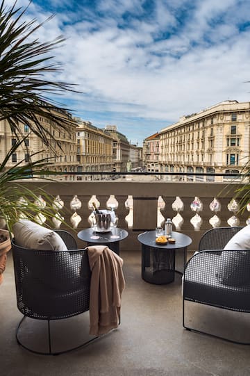 a balcony with chairs and tables