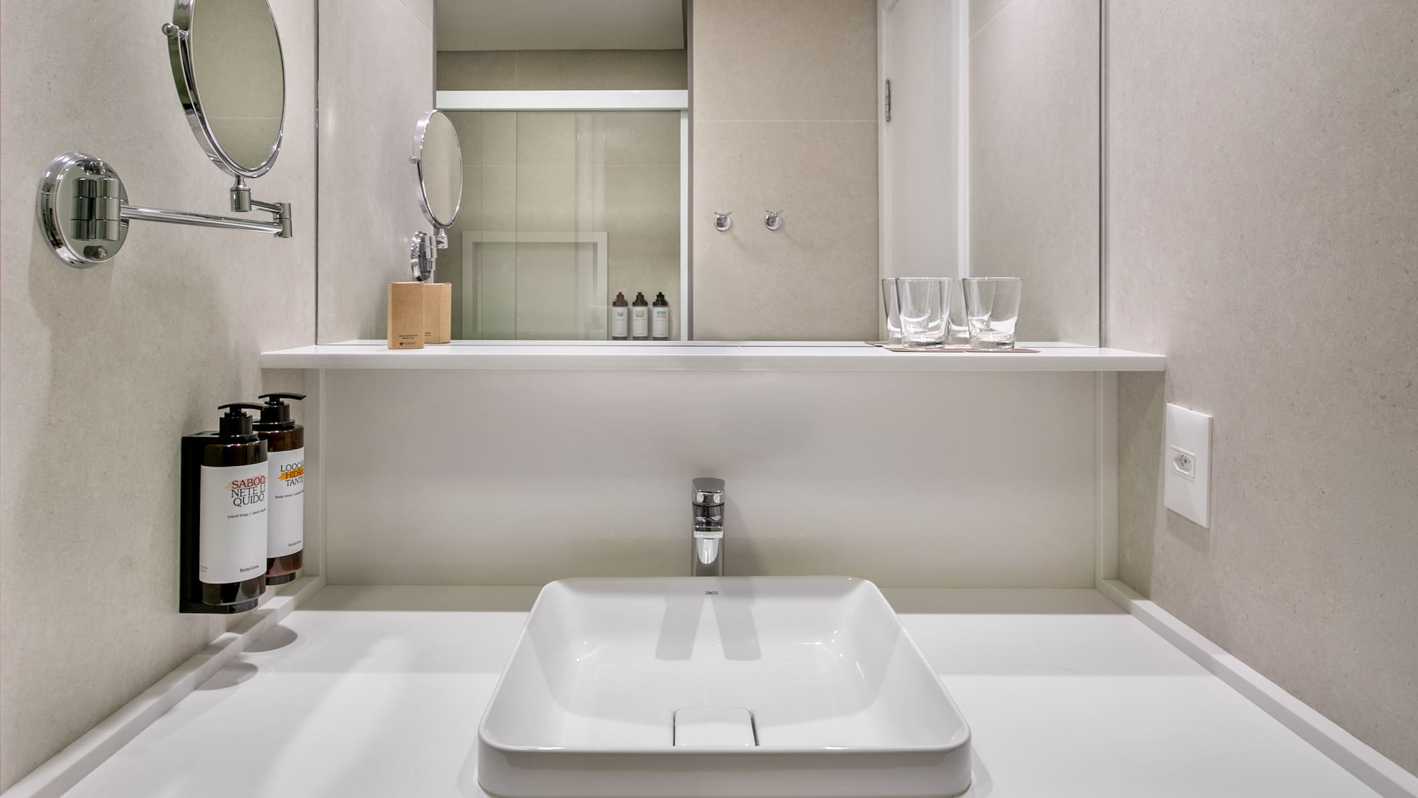 Sleek contemporary bathroom vanity with white sink, chrome faucet, and mirror.