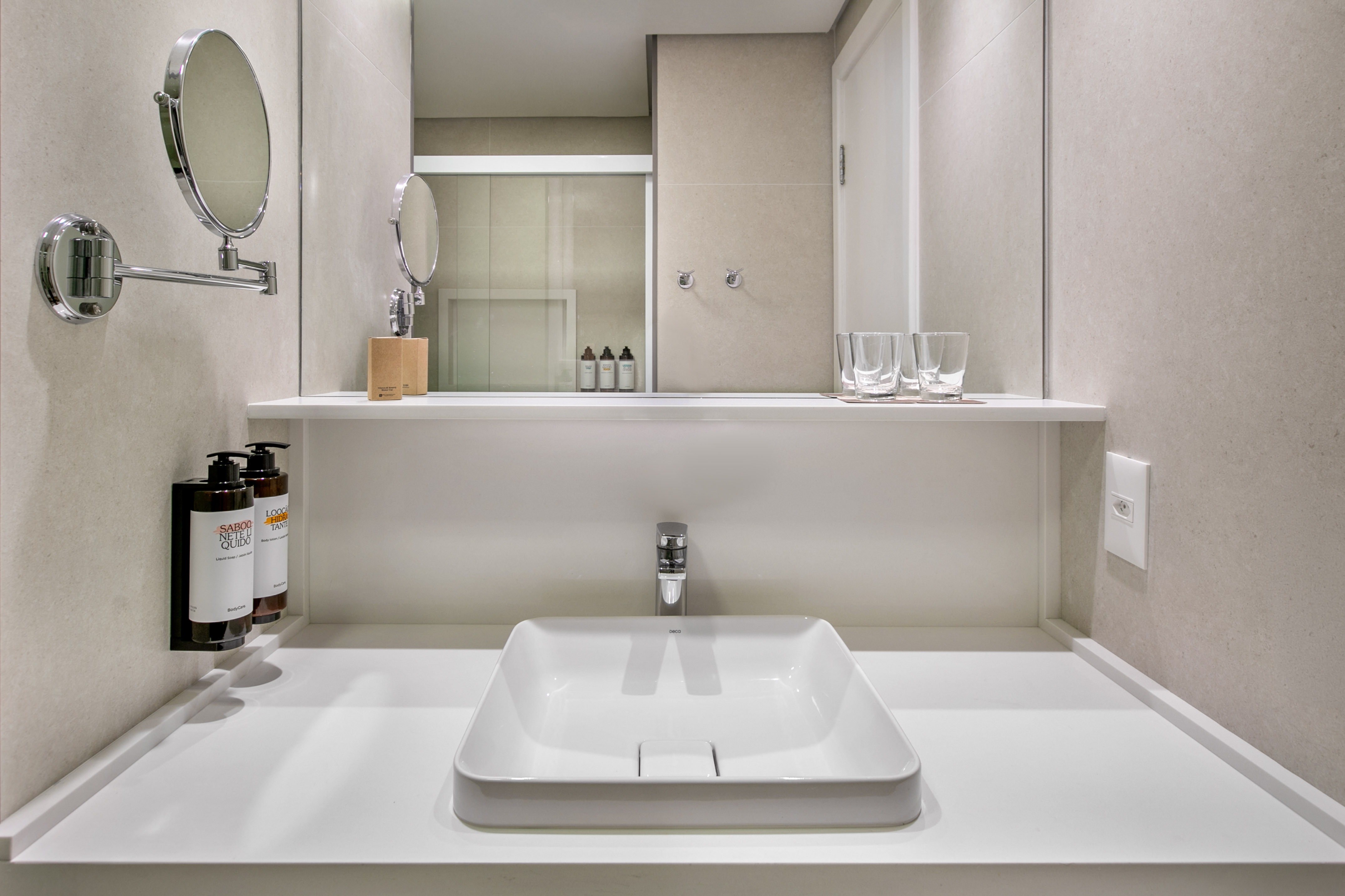 Sleek contemporary bathroom vanity with white sink, chrome faucet, and mirror.