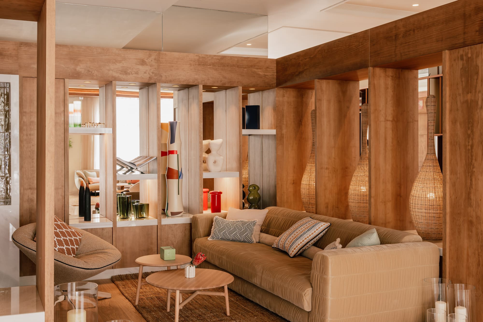 Cozy modern living room with natural wood, plush sofa, armchair, and decorative accents.