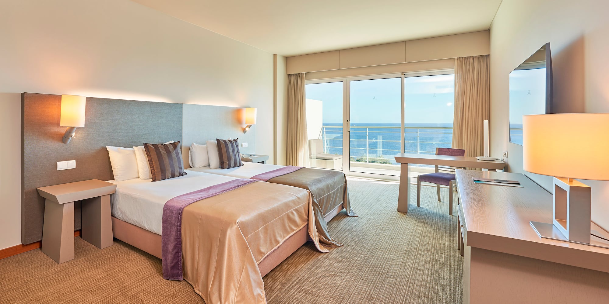 a hotel room with a large bed and a table