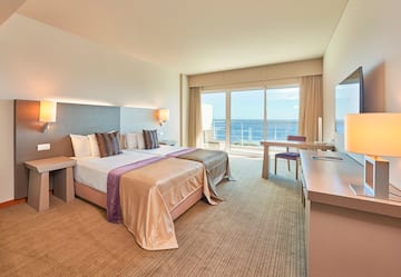 a hotel room with a large bed and a table
