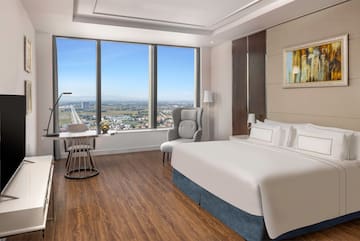 a room with a large window and a bed