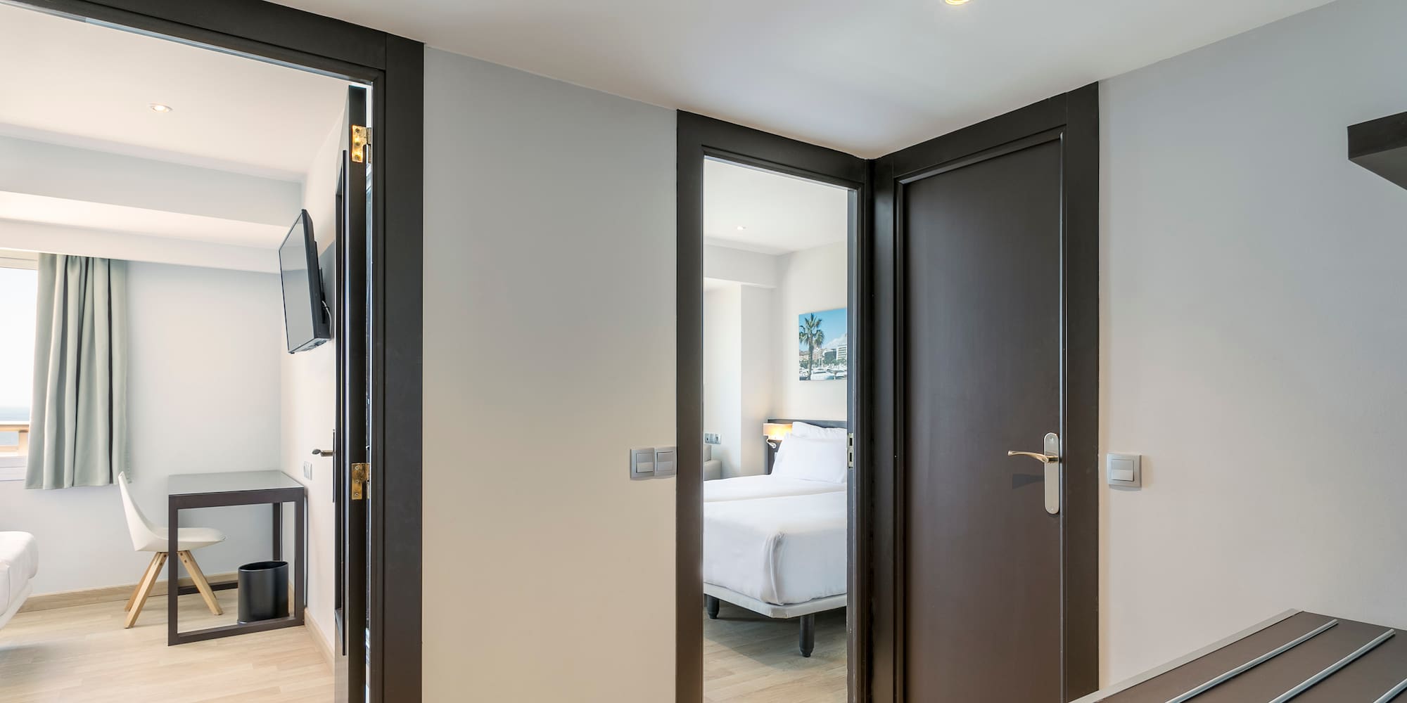 a room with two doors and a bed