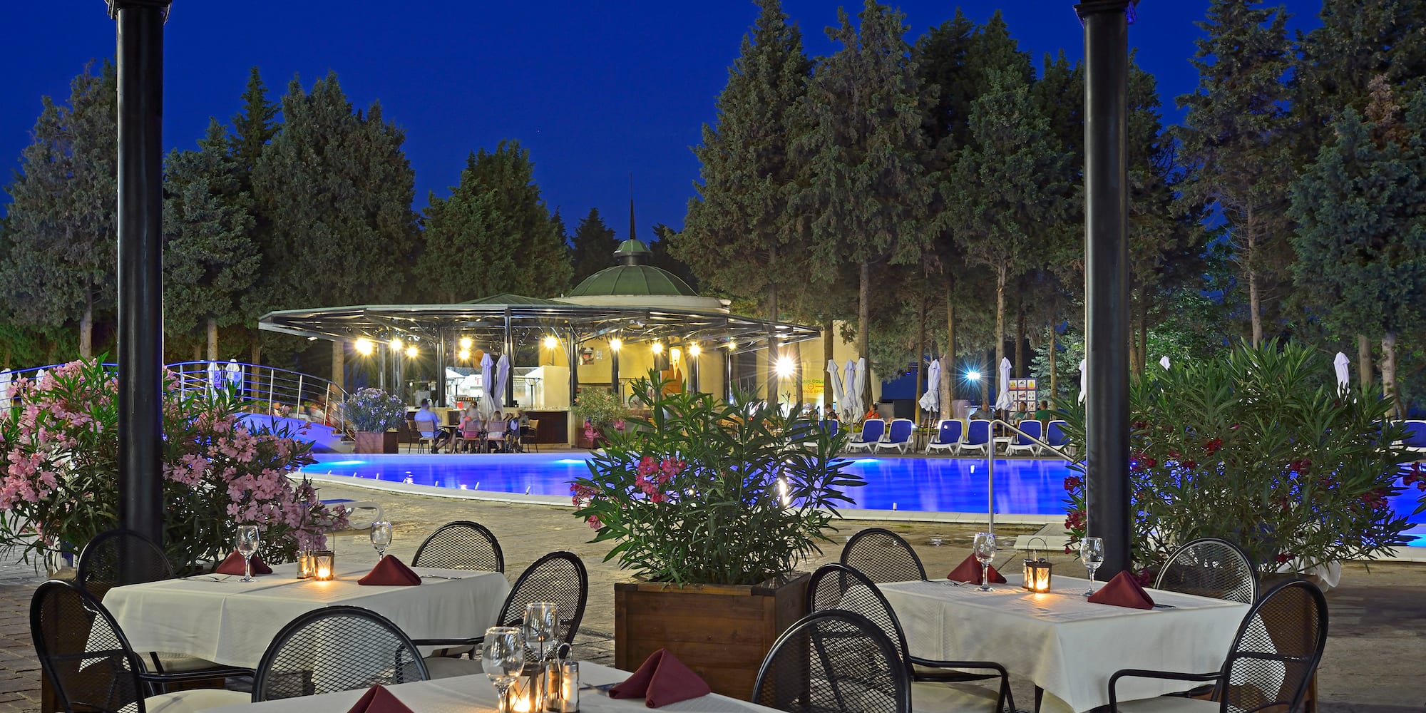 a restaurant with tables and chairs and a pool