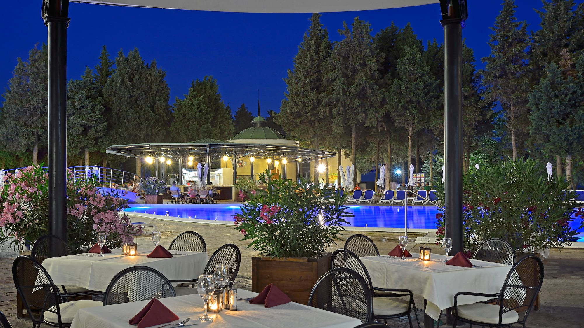 a restaurant with tables and chairs and a pool