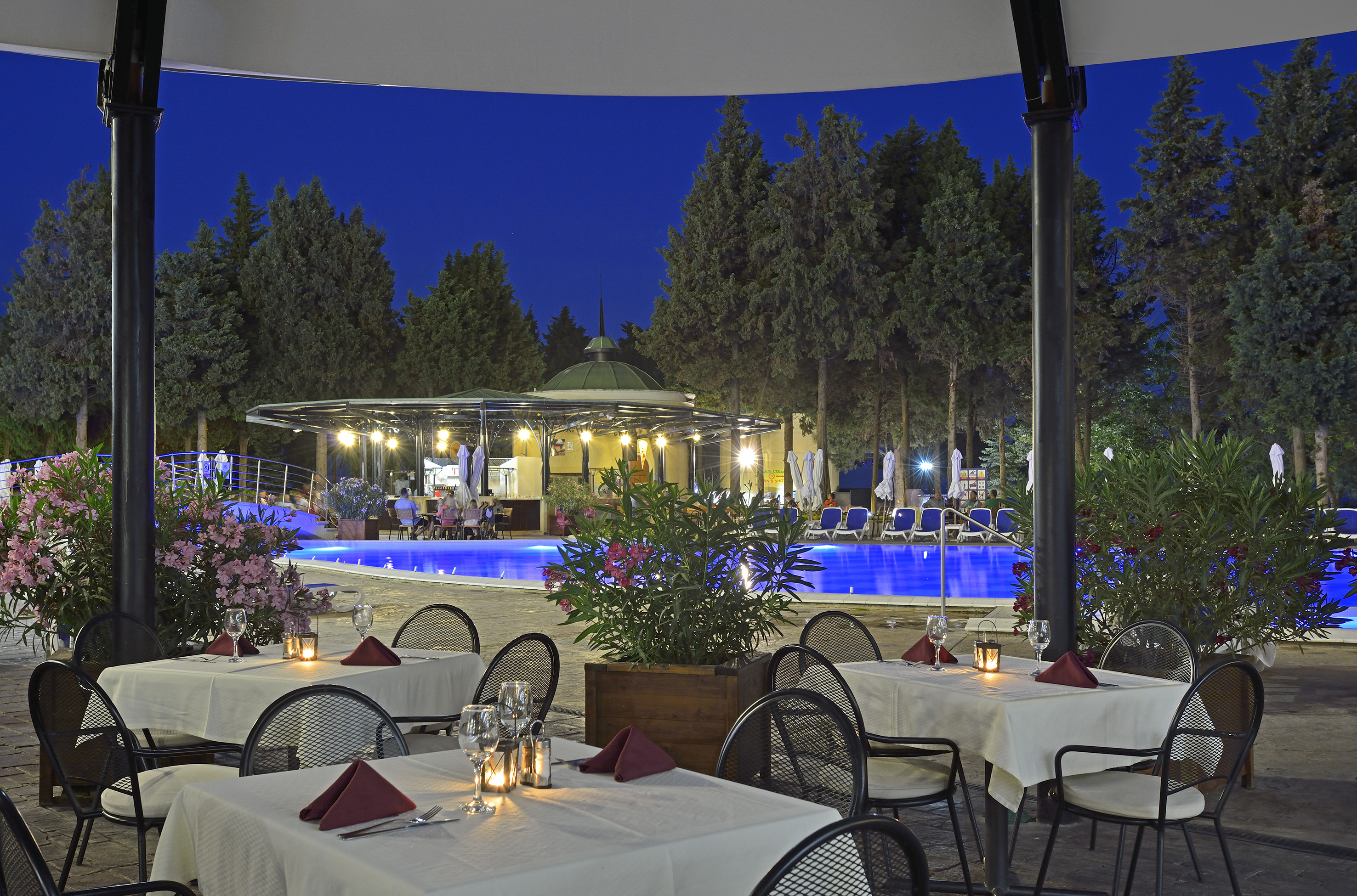 a restaurant with tables and chairs and a pool