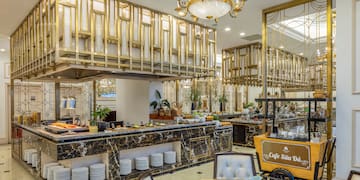 a restaurant with a large counter and chairs