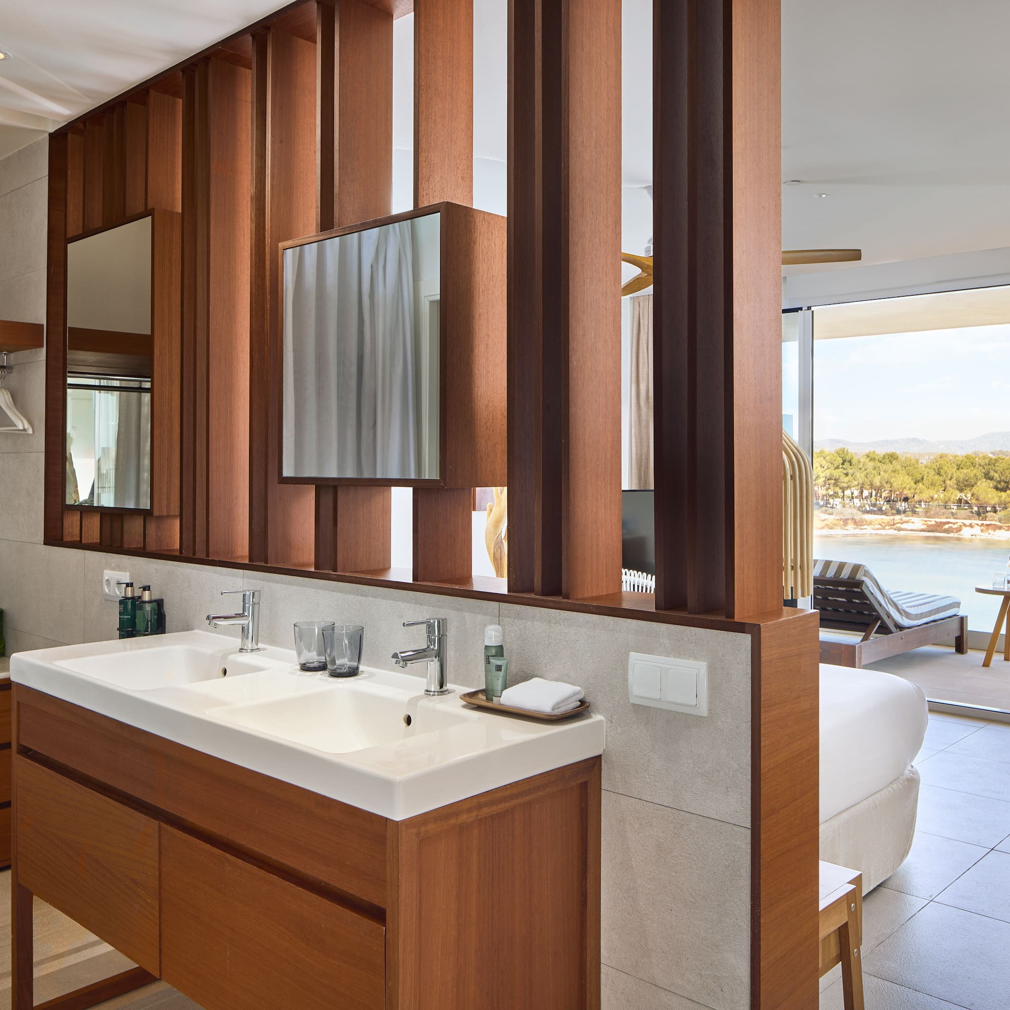 a bathroom with a bed and a mirror