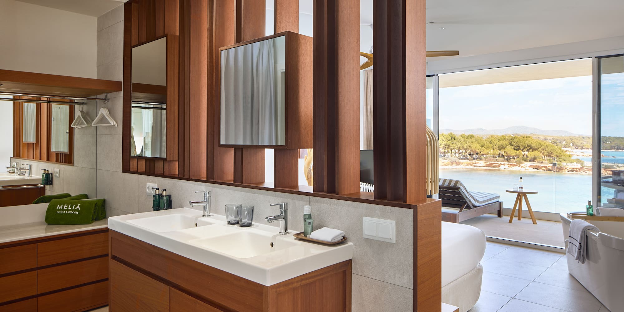 a bathroom with a bed and a mirror