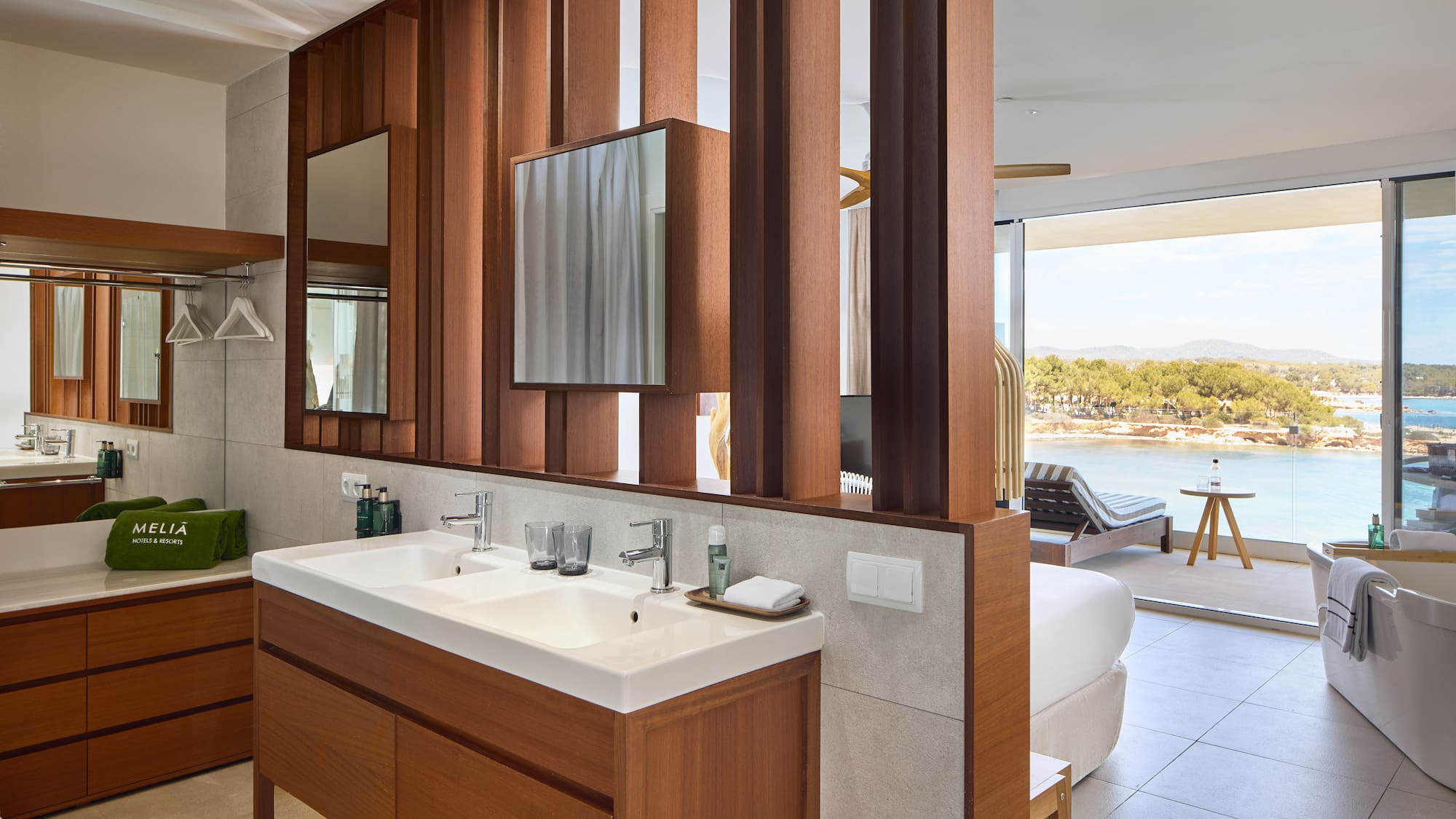 a bathroom with a bed and a mirror