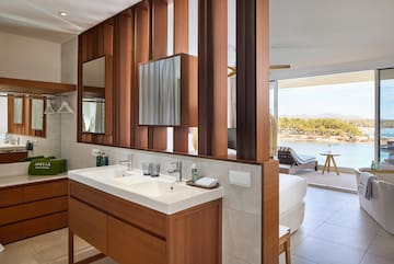 a bathroom with a bed and a mirror