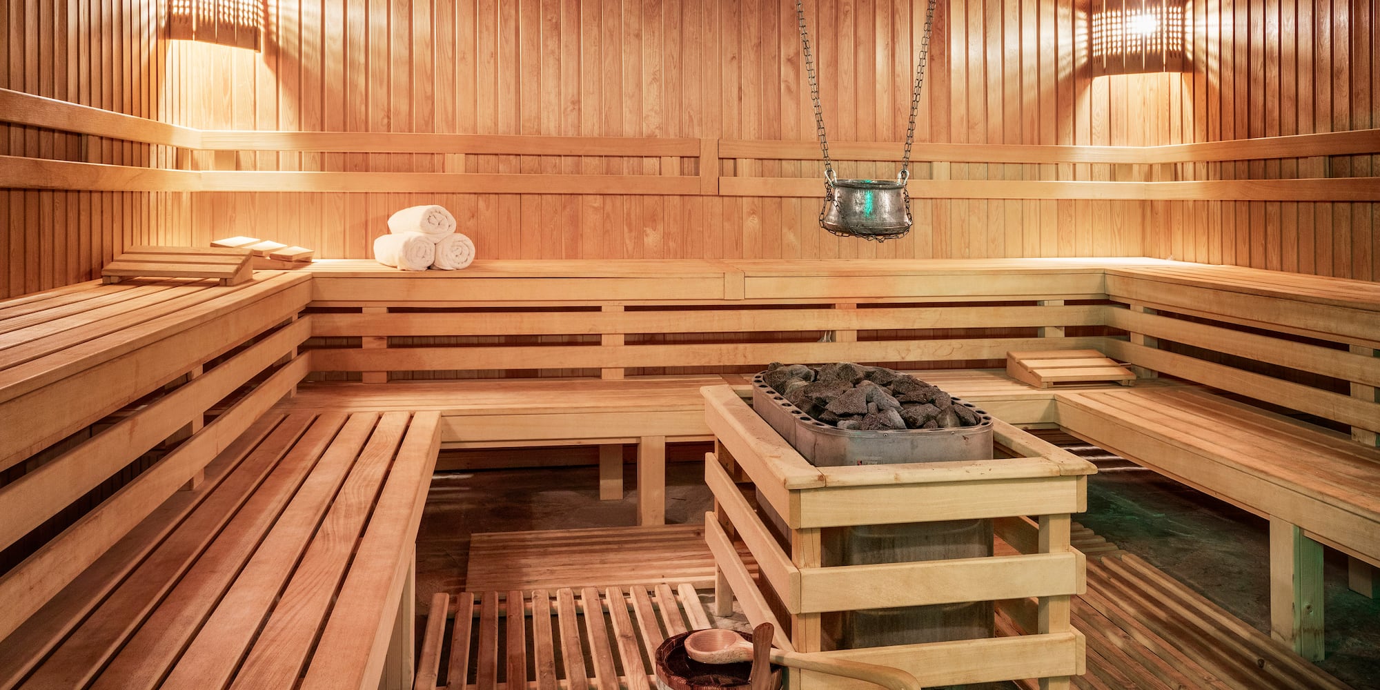 a sauna with wood walls and a bucket of charcoal