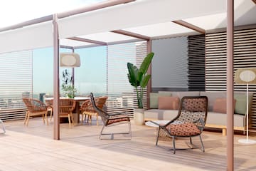 a patio with chairs and a table