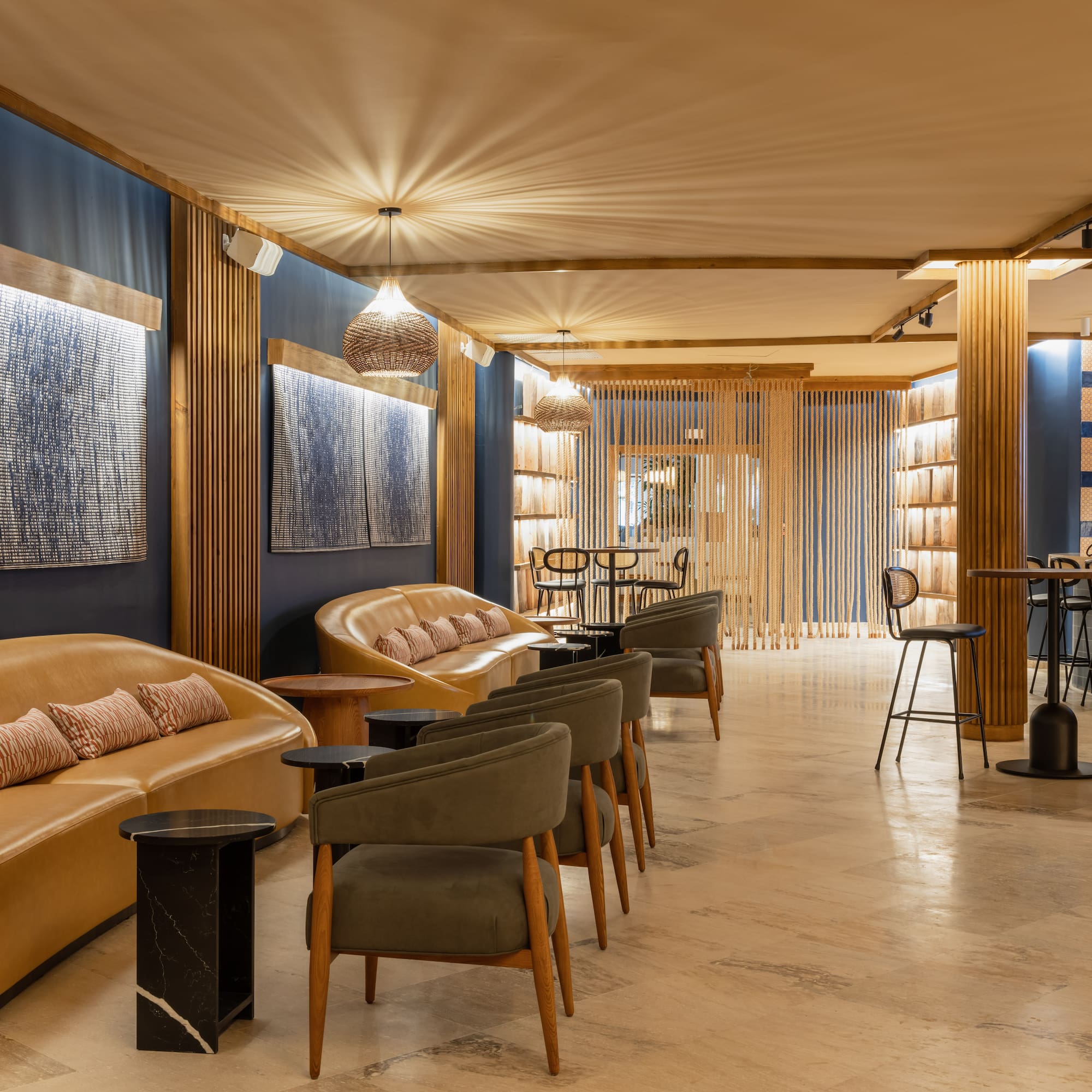 a room with a couch and chairs