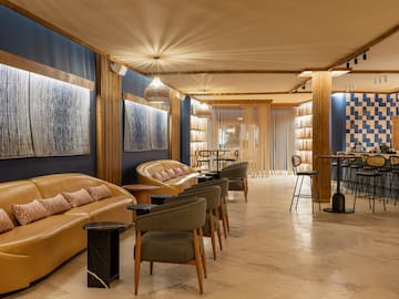 a room with a couch and chairs