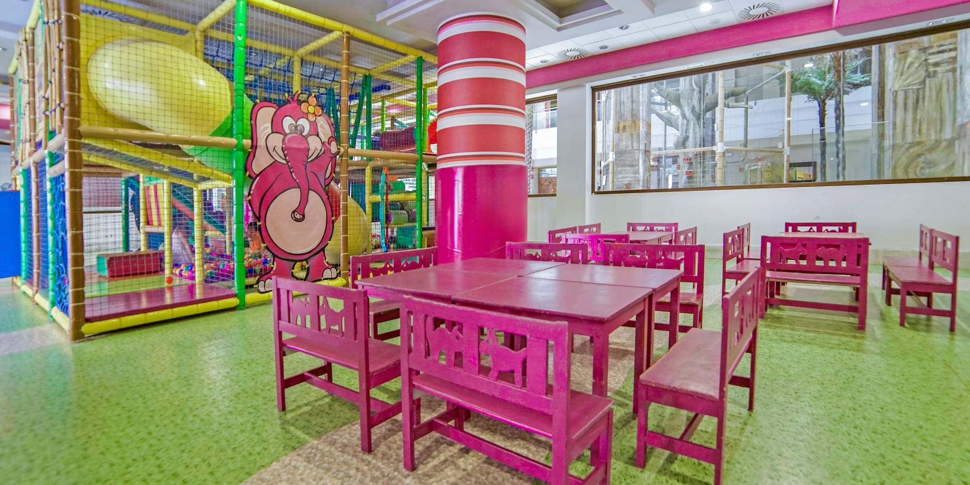 a room with pink chairs and tables