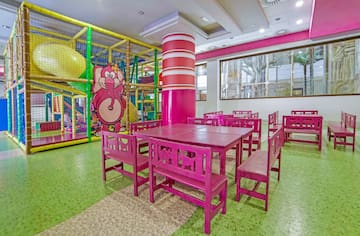 a room with pink chairs and tables