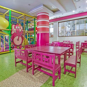 a room with pink chairs and tables