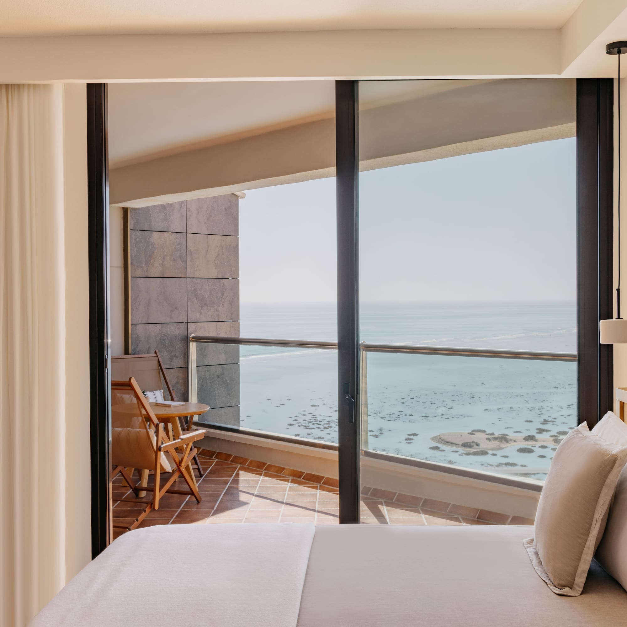 a bedroom with a view of the ocean