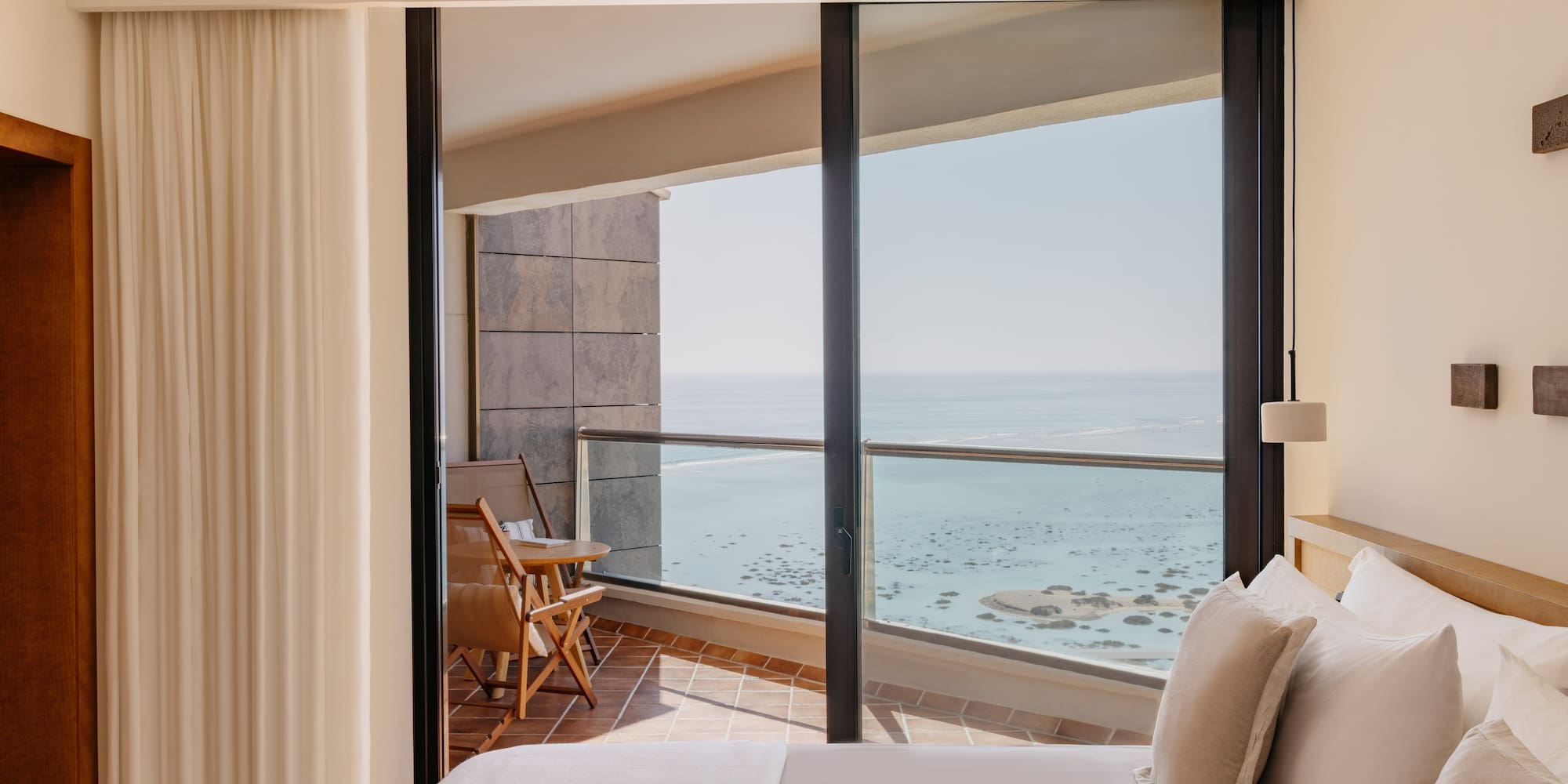 a bedroom with a view of the ocean