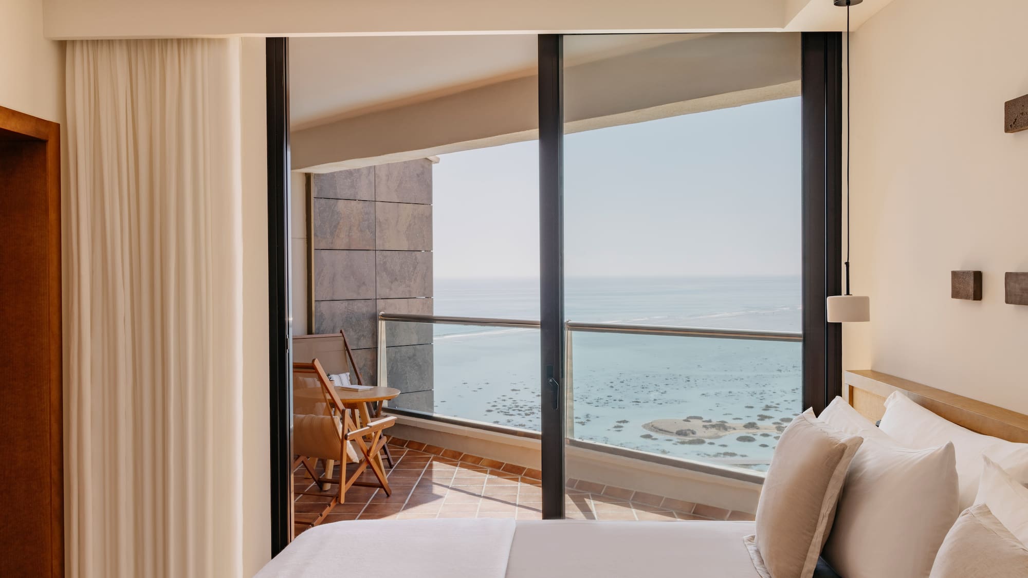 a bedroom with a view of the ocean