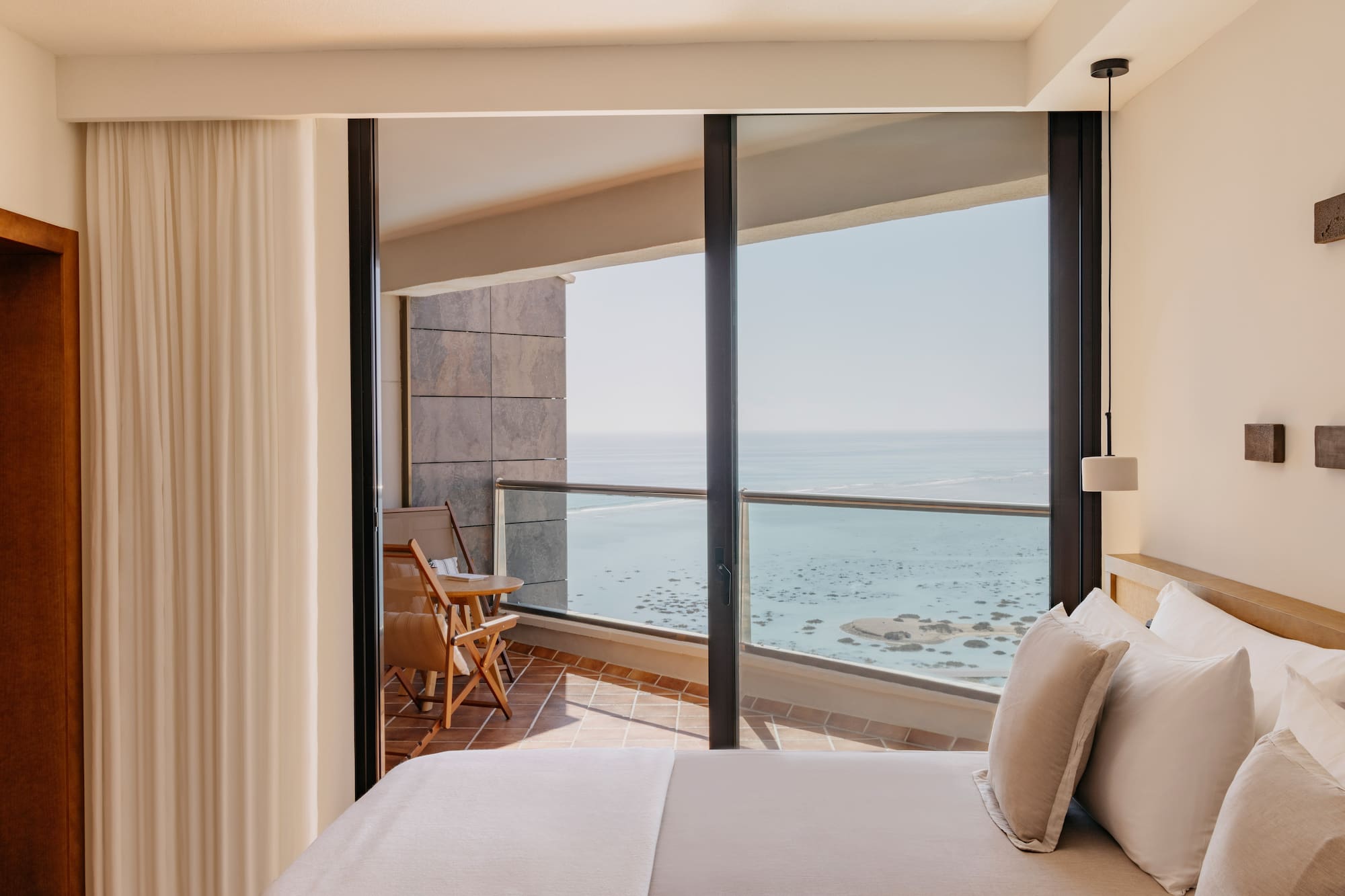 a bedroom with a view of the ocean
