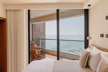 a bedroom with a view of the ocean